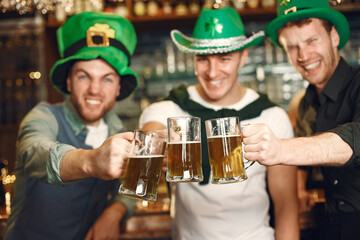 Men celebrate St. Patrick's Day at bar with a mug of beer