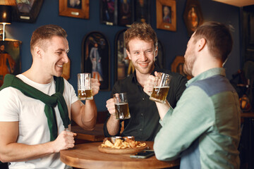 Men celebrate St. Patrick's Day at bar with a mug of beer