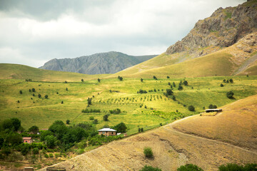Fototapeta na wymiar Mountain chain with green meadows