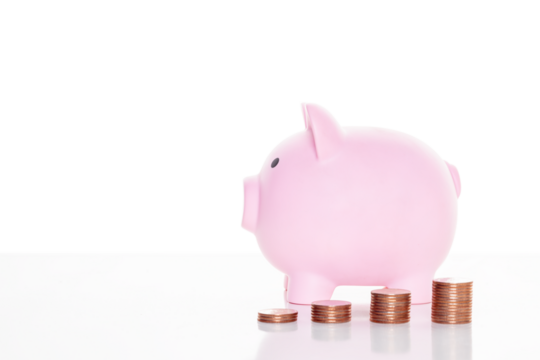 Pink piggy bank and stack of coins