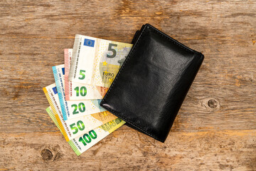 Black leather wallet with euro currency