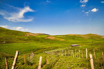 Fototapeta na wymiar Beautiful landscape of green hills and blue sky with white clouds.