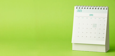 Desk calendar for the month of April 2023 with bright green background - obrazy, fototapety, plakaty