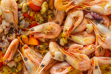 Traditional Spanish paella with seafood cooked for lunch. Delicious Mediterranean risotto with shrimps, octopus, rice and mussels prepared for dinner