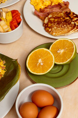halved oranges on table of many colombian breakfast dishes