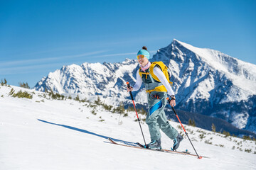 Mountaineer backcountry ski walking ski alpinist in the mountains. Ski touring in alpine landscape...
