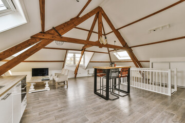 a kitchen and dining area in an attic style home with wood beams on the ceiling, white walls and...