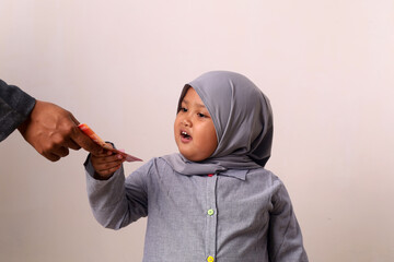 Excited asian muslim little girl receiving money in Eid Al-Fitr day.