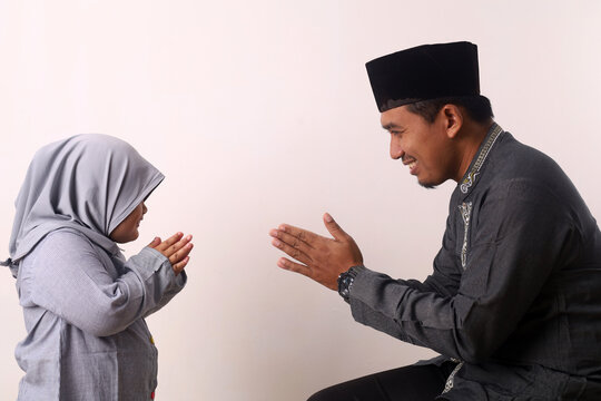 Muslim Family And Kid Greeting And Asking Forgiveness Shaking Hand On Ramadan And Eid Mubarak