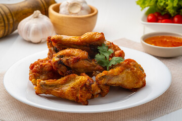Air Fryer drummet chicken wing with Fish Sauce on white plate,less oil frying and crispy