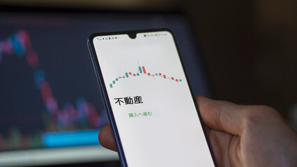 An investor analysing an ETF on a screen. Funds stocks exchange with Japanese text: real estate, buy
