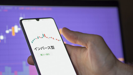 An investor analysing an ETF on a screen. Funds stocks exchange with Japanese text: Inverse type, buy