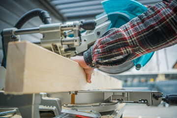 Construction Woodworker Cut a Beam to Size