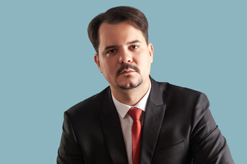 Serious concentrated man man with mustache looking at camera, being attentive and unsmiling.