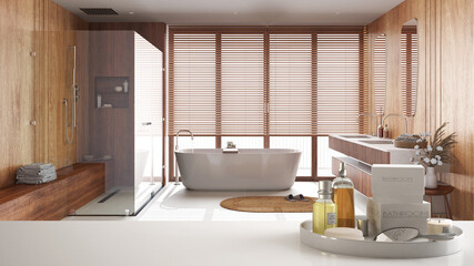 Spa, hotel bathroom concept. White table top or shelf with bathing accessories, toiletries, over wooden minimalist bathroom, modern architecture interior design