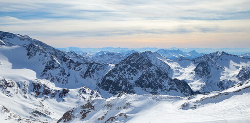 Fototapeta na wymiar Panoramic view of Alps mountain snowy range with skiing trails, Stubai Glacier, Austria