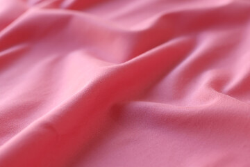 Wavy pink satin fabric background.