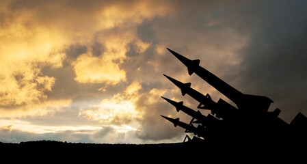 The missiles are aimed at the sky at sunset. Nuclear bomb, chemical weapons, missile defense.