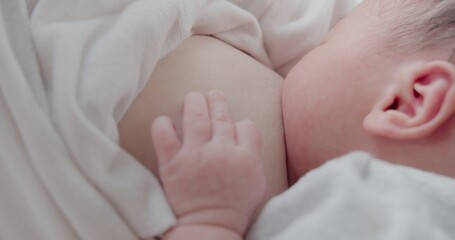 Close up baby suckling milk from mother breast, mom breastfeeding newborn baby infant nursing and...