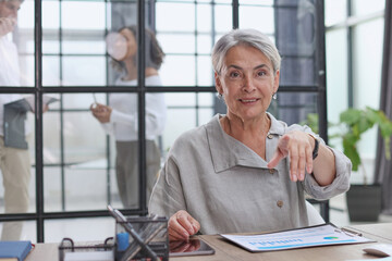woman writes notes. working at the office at the computer