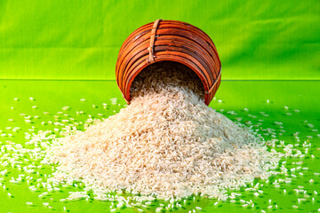Rice measurement handmade cane pot used in Indian kitchens filled with rice and dropped down in...