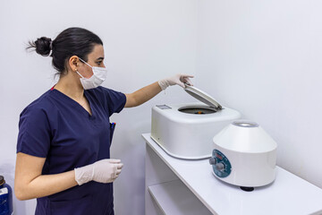 The blood tube is removed from the medical centrifuge for plasma lifting. Prp procedure. Cosmetology and skin care. Platelet-Rich plasma preparation. Tube with blood in hands. Centrifugal.