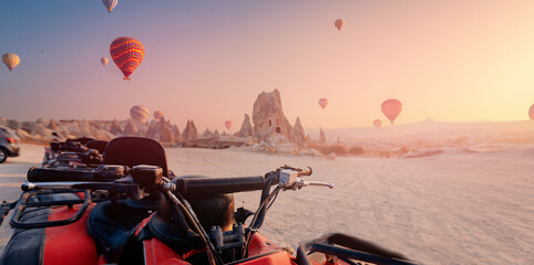Banner ATV quadbike in Cappadocia background set colorful hot air balloon fly in sky with sunset