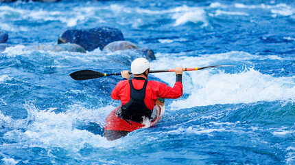 Extreme sport kayaker, back view man in boat kayak whitewater rafting, blue water