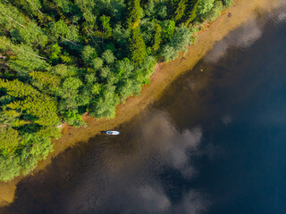 Woman rowing oar on sup board blue sea water. Aerial top view paddleboard