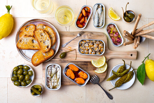 Tinned fish charcuterie board. Seacuterie appetizers platter with canned fish and seafood. Food trend for party and tinned fish date night © sveta_zarzamora