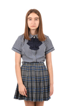 Young beautiful girl in a school uniform on a white background