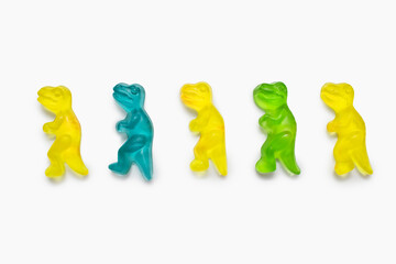 Jelly marmalade candies in the form of dinosaurs on a white background. Colorful sweet...