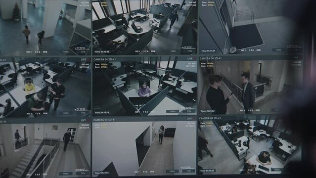 Security operator controls CCTV cameras in business office, uses digital tablet with surveillance cameras playback on screen. High tech security with facial recognition. Monitoring and social safety.