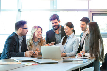 Group of diverse executives having brainstorming business meeting, discussing and reviewing...