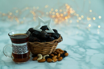 Black tea dates and dry fruits with a star on it , Ramadan and Eid concept 2023