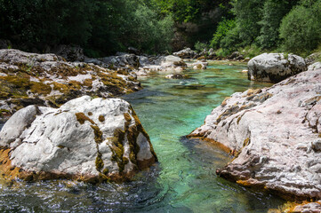 Naklejka na ściany i meble Amazing wild water in mala korita Soce valley, small pure clear turquoise flowing stream through stone gorge