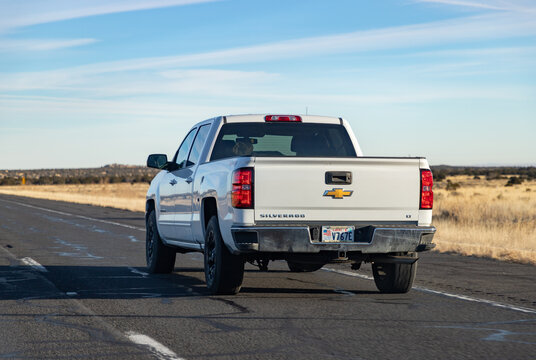 Arizona, United States - November 21, 2022: A picture of a white Chevrolet Silverado LT driving in Arizona.