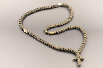 Rosary beads on grey background