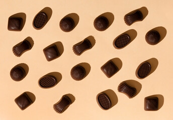 Chocolate candies on a beige background