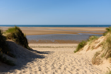 Entrance to Burnham Overy Straithe beach through the sand dunes in North Norfolk