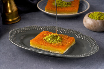 Middle eastern sweets kunefe, kunafa, kadayif with pistachio and syrup .Turkish , arabic traditional dessert.