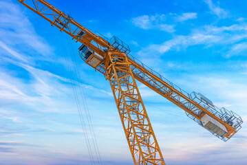 Construction tower crane against the blue sky.