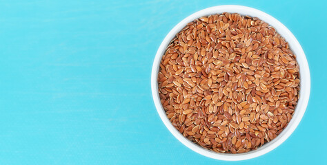 Obraz na płótnie Canvas Organic flax seeds in a bowl, selective focus, space for text.