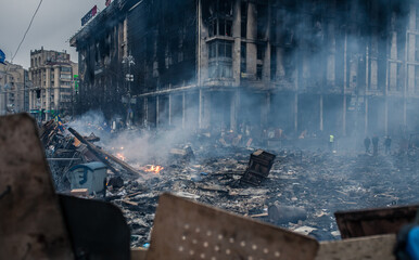 Burned building and barricades at the Maidan square in Kyiv, Ukraine during anti government...