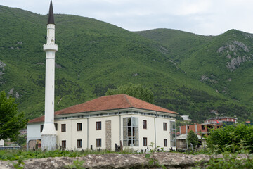 view of a mosque with its minaret built in the mountain of kosovo