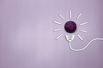 Creative thinking ideas and innovation concept. A purple color ball threads with a light bulb...