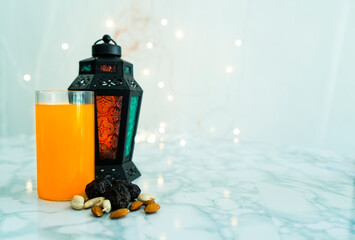 Ramadan and Eid al fitr concept with fresh juice Lantern lamp and dry fruits