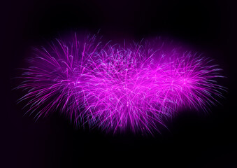 Beautiful purple fireworks display lights up the sky with dazzling display during New Year celebration. Abstract colored fireworks background with copy space. Celebration and anniversary concept
