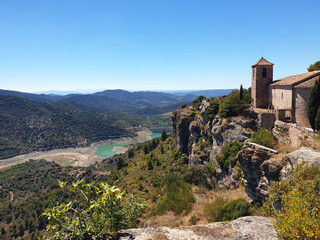 Dry Siurana reservoir during the summer, view of the medieval village of Siurana with the river almost dry, drought in Catalonia, Spain
