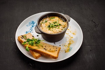 Fresh onion cream soup and crottons on wooden background